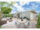 Cozy backyard patio featuring outdoor dining, seating, and tasteful landscaping at 5735 E Mcdowell Rd # 67, Mesa, AZ 85215