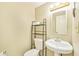 This bathroom offers tile flooring, neutral paint, a pedestal sink, and a toilet with storage at 5735 E Mcdowell Rd # 67, Mesa, AZ 85215