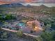 Aerial view of estate with pool, lush landscaping, and mountain views at 6524 E Rockaway Hills Dr, Cave Creek, AZ 85331