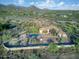 Scenic aerial view of a desert home, showcasing native landscaping, a pool, and picturesque mountain views at 6524 E Rockaway Hills Dr, Cave Creek, AZ 85331