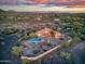 Sunset aerial view of an estate with pool, mature landscaping, and desert mountain backdrop at 6524 E Rockaway Hills Dr, Cave Creek, AZ 85331