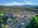 High-angle aerial view of house with tile roof and solar panels, pool and desert landscaping against a mountain backdrop at 6524 E Rockaway Hills Dr, Cave Creek, AZ 85331