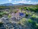 Expansive aerial view of home with tile roof and mountain views, showcasing the desert landscape and solar panels at 6524 E Rockaway Hills Dr, Cave Creek, AZ 85331