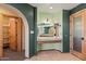Bathroom vanity with tile floors, decorative arches, and lighting at 6524 E Rockaway Hills Dr, Cave Creek, AZ 85331