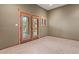 Cozy bedroom with neutral walls, carpet, and stylish wood-trimmed doors and window at 6524 E Rockaway Hills Dr, Cave Creek, AZ 85331