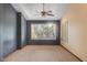 Bright bedroom featuring a ceiling fan and plantation shutters at 6524 E Rockaway Hills Dr, Cave Creek, AZ 85331
