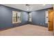 Spacious bedroom featuring neutral carpeting, natural trim, and bright windows at 6524 E Rockaway Hills Dr, Cave Creek, AZ 85331