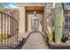 Elegant front entrance with custom iron door, desert landscaping, and privacy gate at 6524 E Rockaway Hills Dr, Cave Creek, AZ 85331