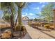 Beautiful desert-landscaped front yard with mature cacti, an arched walkway and rock features at 6524 E Rockaway Hills Dr, Cave Creek, AZ 85331