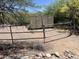 Fenced Arizona horse property with metal containers for storage and native landscaping at 6524 E Rockaway Hills Dr, Cave Creek, AZ 85331
