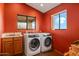 Laundry room with a sink and a front-load washer and dryer at 6524 E Rockaway Hills Dr, Cave Creek, AZ 85331