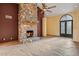 Cozy living room with a floor-to-ceiling stone fireplace, unique flooring, and custom iron doors at 6524 E Rockaway Hills Dr, Cave Creek, AZ 85331