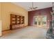Open living room with stone floors, built-in shelving, and a large window that lets in natural light at 6524 E Rockaway Hills Dr, Cave Creek, AZ 85331