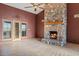 Inviting living room featuring a grand stone fireplace and patio access, perfect for relaxing at 6524 E Rockaway Hills Dr, Cave Creek, AZ 85331