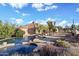 Stunning backyard oasis with a rock waterfall pool, spa, and desert landscaping at 6524 E Rockaway Hills Dr, Cave Creek, AZ 85331