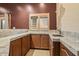 Charming wet bar with wooden cabinets, granite counters, sink, and shuttered window for an inviting space at 6524 E Rockaway Hills Dr, Cave Creek, AZ 85331