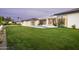 Expansive backyard featuring lush green lawn and minimalist home architecture at 6614 E North Ln, Paradise Valley, AZ 85253