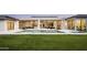 A luxurious backyard features an expansive lawn, a modern pool, and an outdoor dining space at 6614 E North Ln, Paradise Valley, AZ 85253