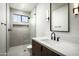 Modern bathroom featuring marble counters, dark hardware, and a glass shower at 6614 E North Ln, Paradise Valley, AZ 85253