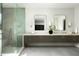 Stylish bathroom with double vanity, quartz countertops, glass shower, and modern mirrors at 6614 E North Ln, Paradise Valley, AZ 85253