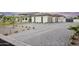 Long driveway leading to a modern home with a three-car garage and meticulously landscaped yard at 6614 E North Ln, Paradise Valley, AZ 85253