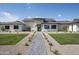 Stunning single-story home featuring a paved walkway, manicured landscaping and exterior stone accents at 6614 E North Ln, Paradise Valley, AZ 85253