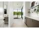Bright hallway with hardwood floors, beverage center, and a view to the outdoor seating area at 6614 E North Ln, Paradise Valley, AZ 85253