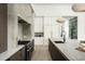 Modern kitchen features an island with stone countertops, stainless steel appliances and designer lighting at 6614 E North Ln, Paradise Valley, AZ 85253