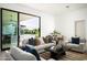 Modern living room with a gray couch, area rug, and sliding door leading to backyard at 6614 E North Ln, Paradise Valley, AZ 85253