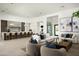 Spacious open-concept living room with modern decor, a large sectional, and adjacent kitchen and wine storage at 6614 E North Ln, Paradise Valley, AZ 85253