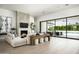 Bright living room features a fireplace, comfortable seating and sliding doors to a backyard with a pool at 6614 E North Ln, Paradise Valley, AZ 85253