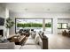 Open-concept living room with modern fireplace, hardwood floors, and seamless indoor-outdoor flow to the pool at 6614 E North Ln, Paradise Valley, AZ 85253