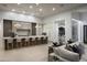Bright open living space with large kitchen island and bar stools, connecting to a living area with modern furnishings at 6614 E North Ln, Paradise Valley, AZ 85253