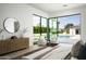 Bedroom with hardwood floors, side table, and large window with a pool view at 6614 E North Ln, Paradise Valley, AZ 85253