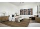 Spacious main bedroom with wooden floors, ceiling fan, sitting area, and neutral decor at 6614 E North Ln, Paradise Valley, AZ 85253