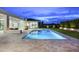 Inviting pool featuring sleek modern design, stone patio, and outdoor living area with a fire pit at 6614 E North Ln, Paradise Valley, AZ 85253