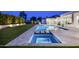 Gorgeous backyard with pool, spa, and travertine decking illuminated at night, ideal for entertaining at 6614 E North Ln, Paradise Valley, AZ 85253