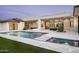 The backyard features a modern pool with water features, a spa, and an outdoor seating area at 6614 E North Ln, Paradise Valley, AZ 85253
