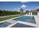 Beautiful backyard featuring a sleek pool, water features, lush green grass, and privacy landscaping at 6614 E North Ln, Paradise Valley, AZ 85253
