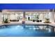 Backyard oasis featuring a sparkling pool, covered patio, and an outdoor dining area at 6614 E North Ln, Paradise Valley, AZ 85253