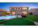 A well-kept backyard with pool, putting green, outdoor seating, and lush green lawn at 6621 S Balboa Dr, Gilbert, AZ 85298