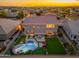 Aerial view of a backyard with a pool, putting green, patio and lush landscaping at 6621 S Balboa Dr, Gilbert, AZ 85298