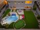 Aerial shot of the backyard featuring a sparkling pool, putting green, and outdoor seating area at 6621 S Balboa Dr, Gilbert, AZ 85298