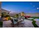 Beautiful backyard with a dining area, patio furniture, lush landscaping, and pool at 6621 S Balboa Dr, Gilbert, AZ 85298