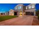Stately two-story home featuring a three car garage, manicured lawn, and a tile roof at 6621 S Balboa Dr, Gilbert, AZ 85298