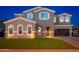 Charming home featuring a three-car garage, a well-kept lawn, and an arched entryway at 6621 S Balboa Dr, Gilbert, AZ 85298