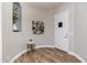 Inviting foyer featuring wood floors, a decorative niche, and a modern accent table at 6621 S Balboa Dr, Gilbert, AZ 85298