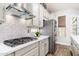 Modern kitchen with white cabinets, stainless steel appliances, and sleek countertops at 6621 S Balboa Dr, Gilbert, AZ 85298