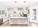Elegant kitchen featuring white cabinetry, stainless steel appliances, and a large island with pendant lighting at 6621 S Balboa Dr, Gilbert, AZ 85298