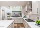 Well-lit kitchen with a view to the living area, featuring modern appliances and sleek countertops at 6621 S Balboa Dr, Gilbert, AZ 85298